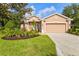 Charming single-story home with a well-manicured lawn, beautiful landscaping, and a two-car garage at 105 New Briton Ct, Bradenton, FL 34212