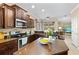 Well-lit kitchen featuring granite countertops, stainless steel appliances, and a view into the living area at 105 New Briton Ct, Bradenton, FL 34212