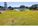 Expansive lawn area with a view of a pond and surrounding trees at 105 New Briton Ct, Bradenton, FL 34212