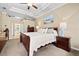 A bright main bedroom with a ceiling fan, ensuite, and neutral tones provides a calming and comfortable living space at 105 New Briton Ct, Bradenton, FL 34212