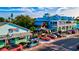 Picturesque street scene showcasing vibrant buildings, palm trees, parked cars, and a tourist golf cart at 105 New Briton Ct, Bradenton, FL 34212