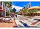 Vibrant street scene featuring colorful storefronts, palm trees, outdoor seating, and pedestrian-friendly walkways at 105 New Briton Ct, Bradenton, FL 34212