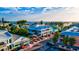 Charming coastal streetscape featuring colorful buildings, palm trees, parked cars, and a view of the ocean at 105 New Briton Ct, Bradenton, FL 34212