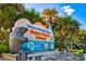 Welcome sign to Anna Maria Island framed by lush palm trees under a sunny sky at 105 New Briton Ct, Bradenton, FL 34212