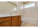 Bright bathroom featuring a vanity, bathtub, and tiled flooring at 4140 Reflections Pkwy, Sarasota, FL 34233