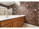 Double vanity bathroom with marble-like wallpaper at 4140 Reflections Pkwy, Sarasota, FL 34233