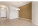 Dining room with tile floors and an elegant chandelier at 4140 Reflections Pkwy, Sarasota, FL 34233
