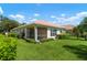 Exterior view of home with landscaped yard at 4140 Reflections Pkwy, Sarasota, FL 34233