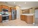 Kitchen features island, stainless steel appliances, and oak cabinets at 4140 Reflections Pkwy, Sarasota, FL 34233