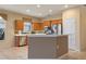 Kitchen boasts island, stainless steel appliances, and oak cabinets at 4140 Reflections Pkwy, Sarasota, FL 34233