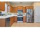 Bright kitchen with stainless steel appliances and oak cabinets at 4140 Reflections Pkwy, Sarasota, FL 34233