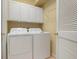 Laundry room with washer, dryer, and cabinets at 4140 Reflections Pkwy, Sarasota, FL 34233