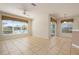 Bright living room with tile floors and large windows at 4140 Reflections Pkwy, Sarasota, FL 34233