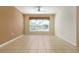 Living room with tile floors, neutral walls, and a ceiling fan at 4140 Reflections Pkwy, Sarasota, FL 34233