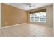 Living room with tile floors, neutral walls, and a ceiling fan at 4140 Reflections Pkwy, Sarasota, FL 34233