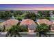 Three villas next to a lake at sunset at 3207 77Th E Dr, Sarasota, FL 34243