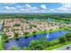 Aerial view of lakefront community with houses at 3207 77Th E Dr, Sarasota, FL 34243