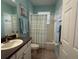 Clean bathroom with tub shower, vanity, and dark countertop at 3207 77Th E Dr, Sarasota, FL 34243