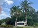 Palm Lakes community entrance with palm trees and signage at 3207 77Th E Dr, Sarasota, FL 34243