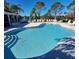 Community pool with ample deck space and lounge chairs at 3207 77Th E Dr, Sarasota, FL 34243