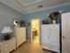 Bright bedroom with white dresser and ensuite bathroom at 8251 Varenna Dr, Sarasota, FL 34231