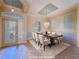 Virtually staged dining room featuring modern decor, chandelier, and a beautifully set table at 3108 Royal Palm Dr, North Port, FL 34288