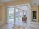 Virtually staged patio area with sheer curtains, a view of the screened in lanai, and pool at 3108 Royal Palm Dr, North Port, FL 34288