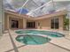 Beautiful pool and patio area featuring a built-in spa, tile surround, and multiple access points at 3108 Royal Palm Dr, North Port, FL 34288