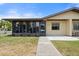 Front view of a tan single-story home with a walkway at 4109 66Th Street W Cir # 4109, Bradenton, FL 34209