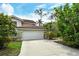 Front view of a townhome with attached garage and driveway at 7673 Fairway Woods Dr # 706, Sarasota, FL 34238