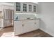 Charming bar area features white cabinets with a marble counter and display cases at 1741 Jewel Dr, Sarasota, FL 34240