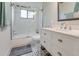 Modern bathroom featuring stylish vanity, updated fixtures, and tiled shower-tub combination at 1741 Jewel Dr, Sarasota, FL 34240