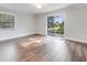 Spacious bedroom with hardwood floors, natural light from the window and view of the back yard at 1741 Jewel Dr, Sarasota, FL 34240