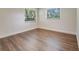 A bedroom with hardwood floors with natural light from two windows at 1741 Jewel Dr, Sarasota, FL 34240