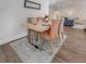 Dining area with elegant wood table, seating for four, and stylish rug, perfect for entertaining guests at 1741 Jewel Dr, Sarasota, FL 34240