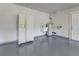 Spacious garage with a utility sink, refrigerator, and painted floor at 1741 Jewel Dr, Sarasota, FL 34240