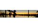 Stunning sunset view over a serene lake, showcasing the property's waterfront location at 177 Vinadio Blvd, Nokomis, FL 34275