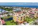 Stunning aerial view of a beautiful home with green roof, a pond, and community near the ocean at 1450 Silvia Shores Dr, Apollo Beach, FL 33572