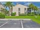 Condo building with parking and tropical landscaping at 26336 Nadir Rd # 12, Punta Gorda, FL 33983