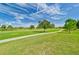 Landscaped golf course with walking path and lush green grass at 26336 Nadir Rd # 12, Punta Gorda, FL 33983