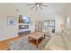 Spacious living room with vaulted ceiling, hardwood floors, and large TV at 26336 Nadir Rd # 12, Punta Gorda, FL 33983