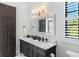 Elegant bathroom with a double vanity and marble countertops at 3482 Flamingo Ave, Sarasota, FL 34242