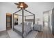 Bright bedroom with a four-poster bed and access to a hallway at 3482 Flamingo Ave, Sarasota, FL 34242