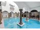 Inviting indoor pool with arched colonnade and checkered floor at 3482 Flamingo Ave, Sarasota, FL 34242