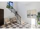 Elegant staircase with black metal railing and checkerboard flooring at 3482 Flamingo Ave, Sarasota, FL 34242