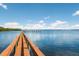 Long wooden dock extending over calm water under a sunny sky at 3705 E Bay Dr # 115, Holmes Beach, FL 34217