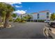 Building exterior showcasing attractive landscaping and parking at 3705 E Bay Dr # 115, Holmes Beach, FL 34217