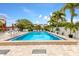 Inviting community pool with lounge chairs under palm trees at 3705 E Bay Dr # 115, Holmes Beach, FL 34217