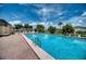 Community swimming pool with brick patio and lounge chairs at 6428 Fleetwood Ct, North Port, FL 34287