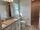 Bathroom with granite countertops, double vanity, and a walk-in shower at 8005 Tropicaire Blvd, North Port, FL 34291